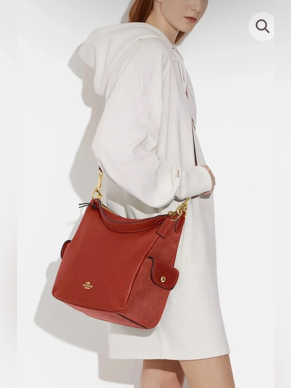 Coach Pennie Shoulder Bag features gold hardware and side suede pockets